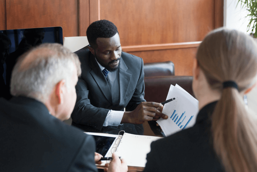 Two men and a woman review documents on the liquidity crisis.