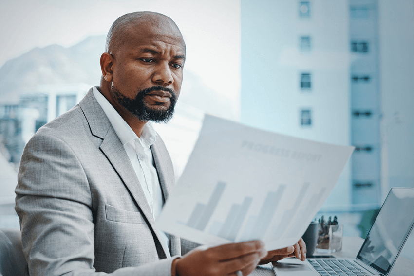 A man reviewing information about the importance of governance, risk and compliance during a recession. 