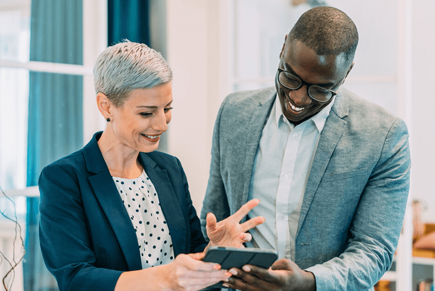 A woman and a man going over 2023 accounting and finance hiring trends.