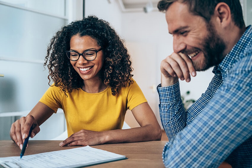 A woman and man going over a document about corporate and administrative hiring trends.