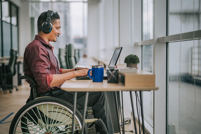 Man in wheelchair sitting at desk working