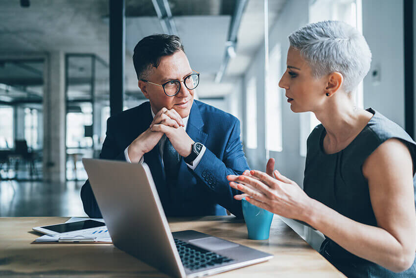 A man and woman building a feedback-rich enviornment at work.