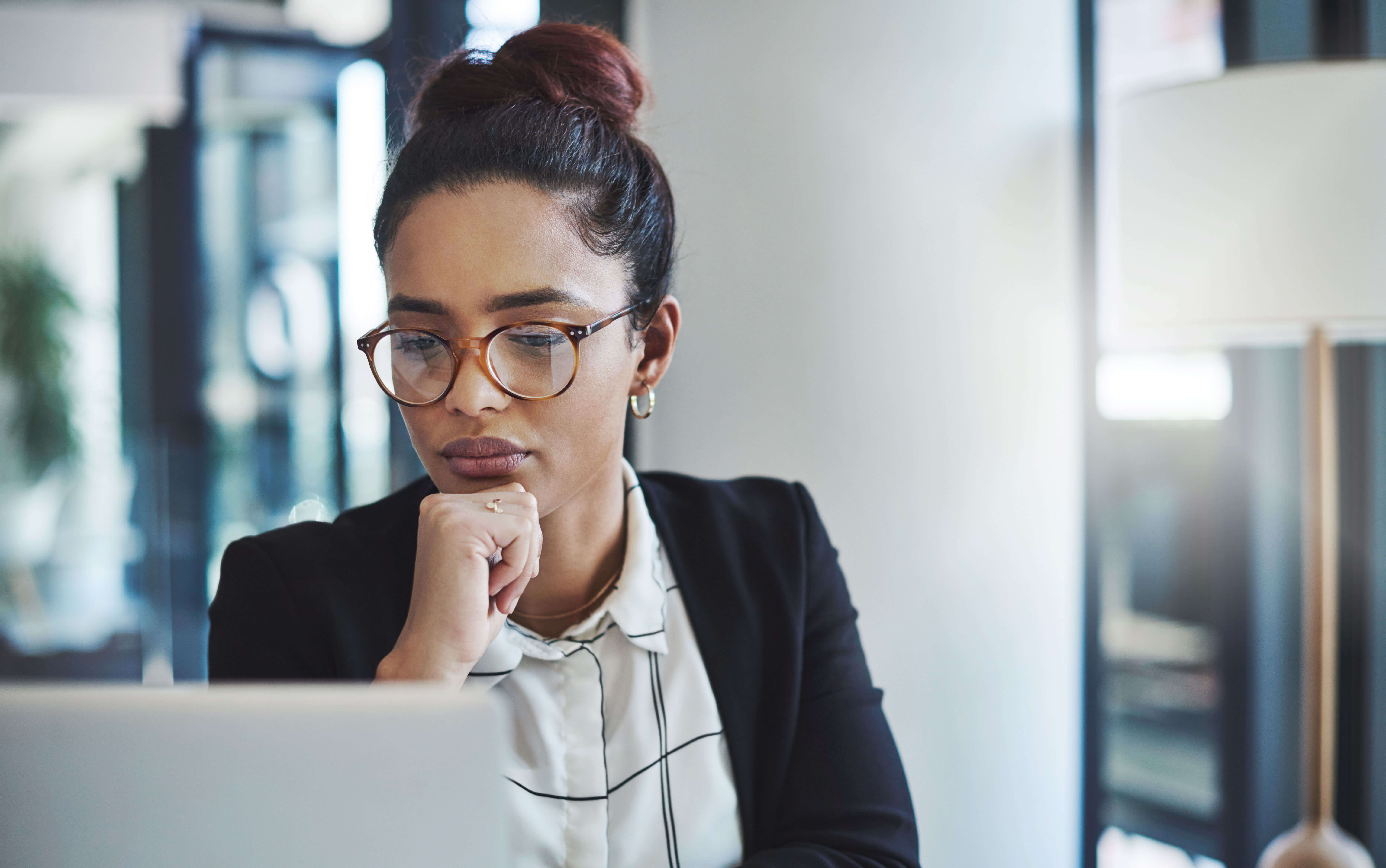 Woman looks at laptop