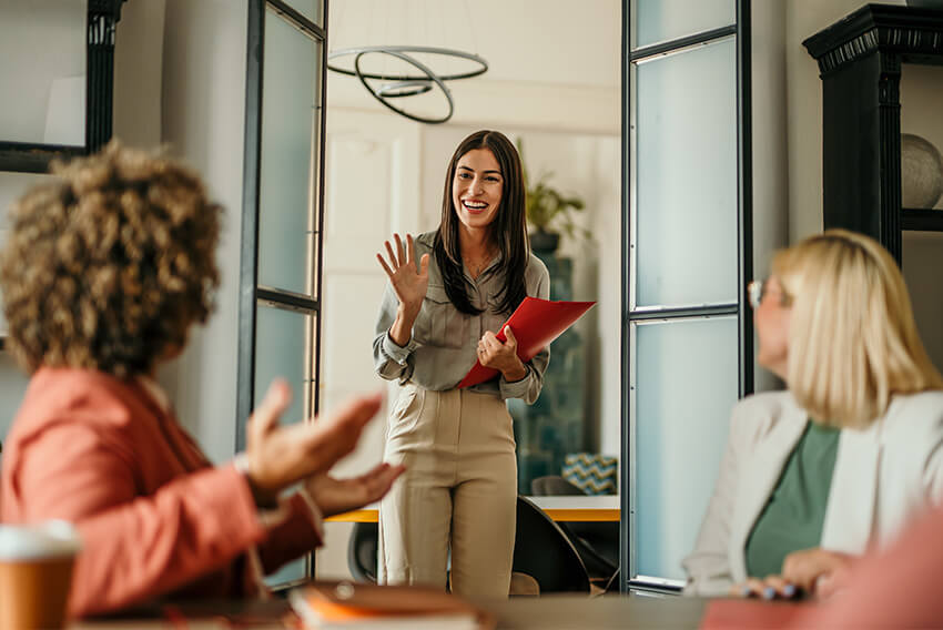 Female job candidate asking the interviewer good interview questions during a job interview.