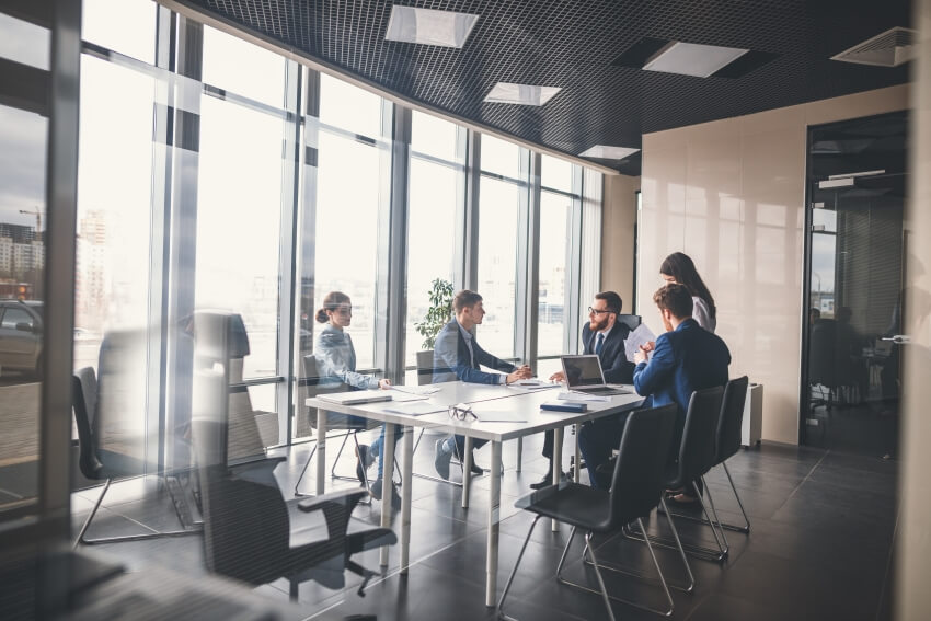 group gathering around a conference table | Astoncarter.com