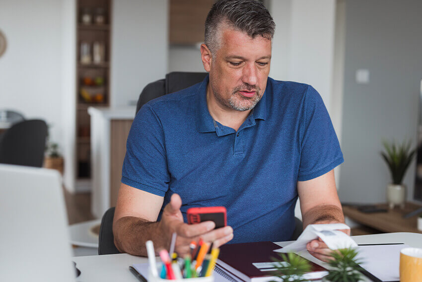 A male working on travel and expense accounting processes and reports.