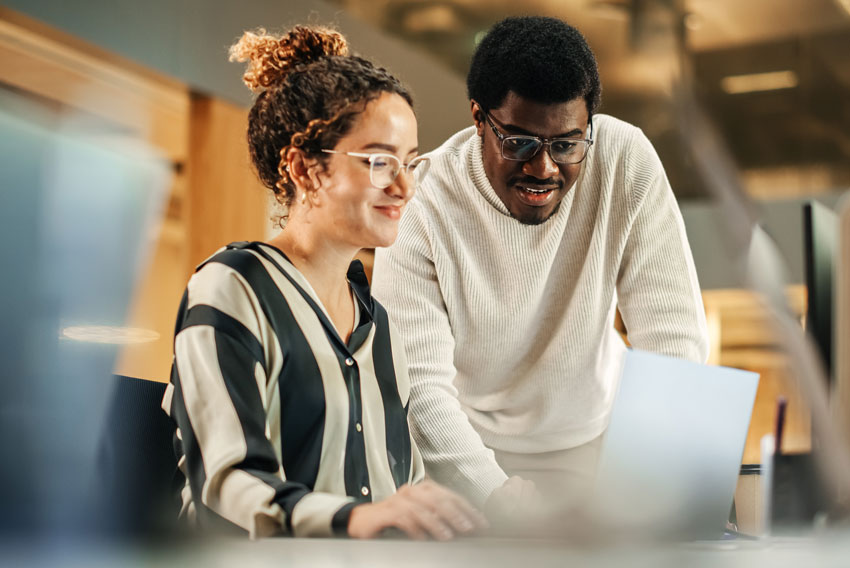 A female and male reviewing the April 2024 jobs report to look at March labor market trends.