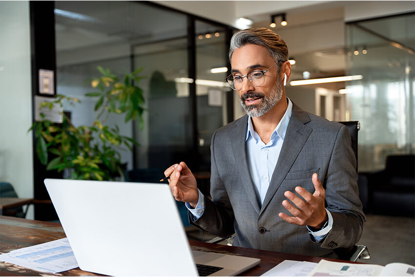 Male professional on a zoom call discussing the April 2025 jobs report looking at March labor market and economy trends.