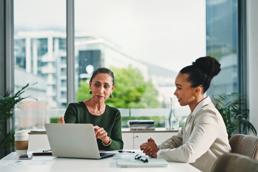 Female professionals reviewing the April 2026 jobs report looking at March 2026 labor market and economy trends.