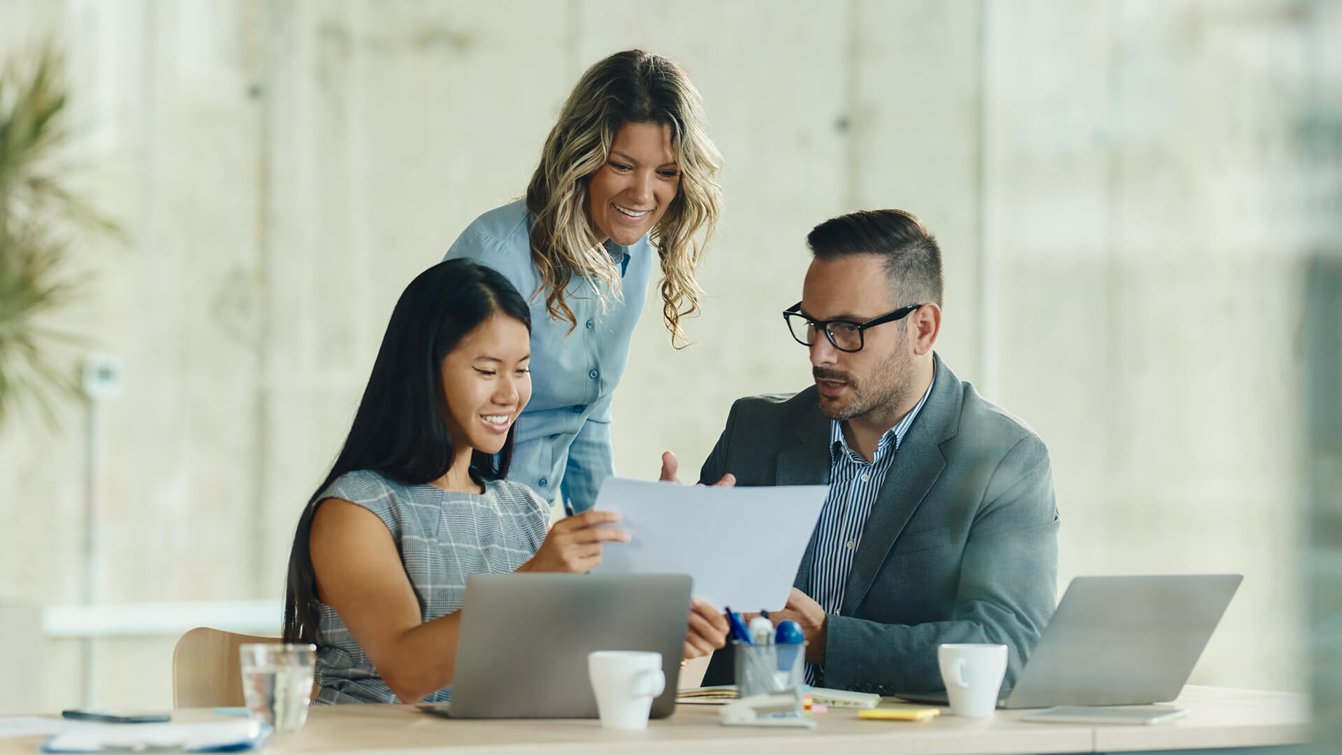 A group of coworkers reviewing the August 2025 jobs reporting looking at July 2025 labor market and economy trends.