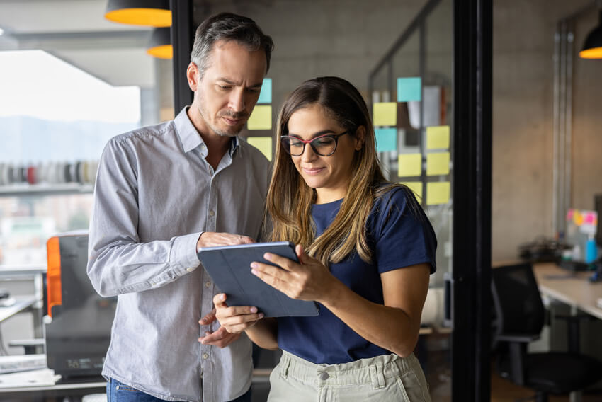 Man and woman reviewing the February 2024 jobs report.