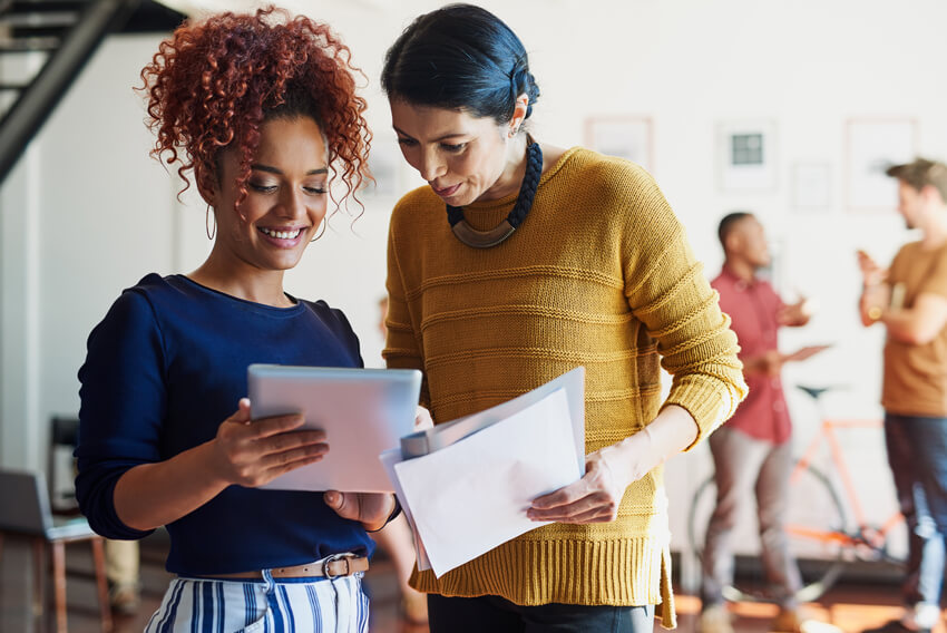 Professionals reviewing the May 2026 jobs report looking at April labor market and economy trends.