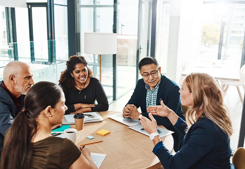 A diverse group of people having a discussion at a table